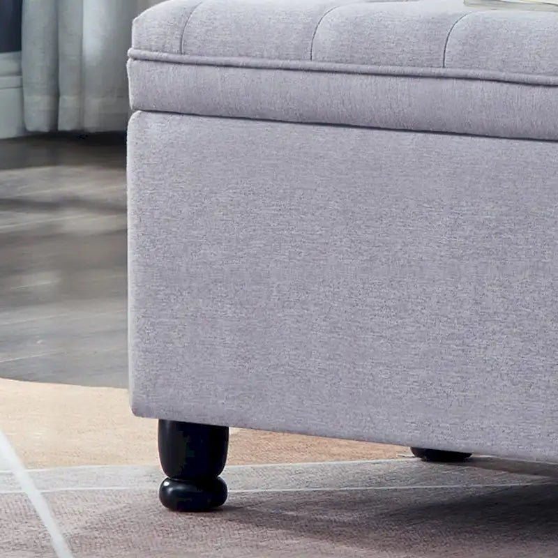 Banc de rangement capitonné avec pieds fuselés en bois